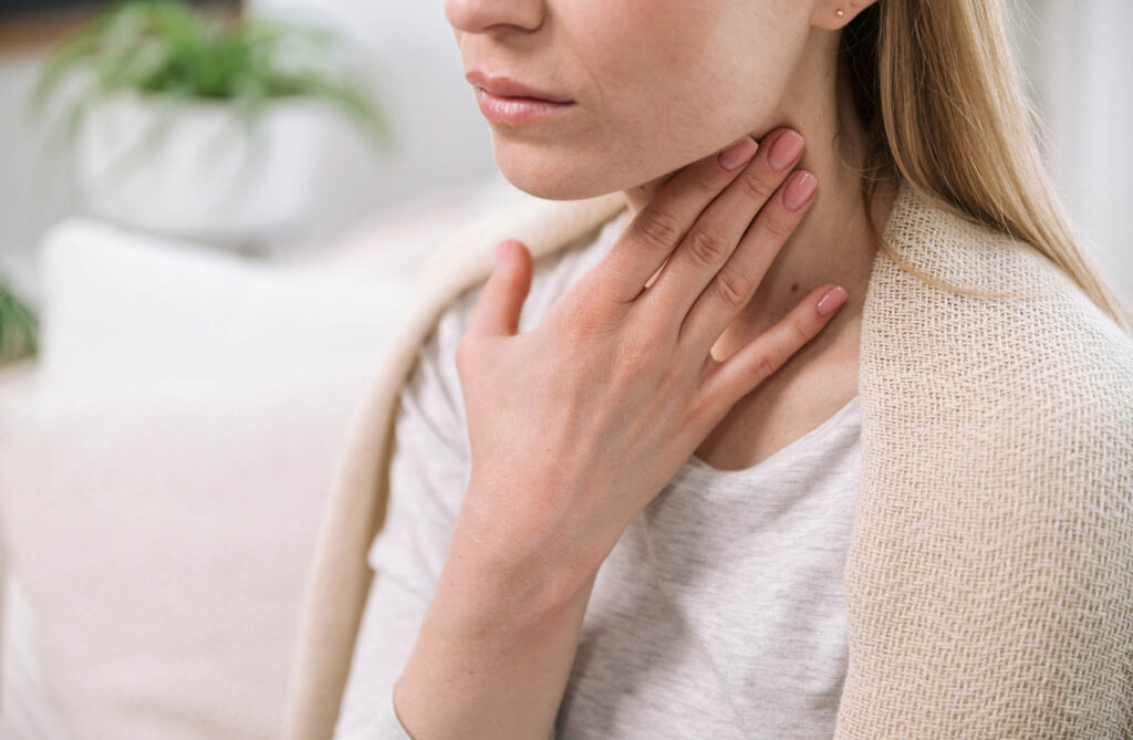 Woman suffering from sore throat