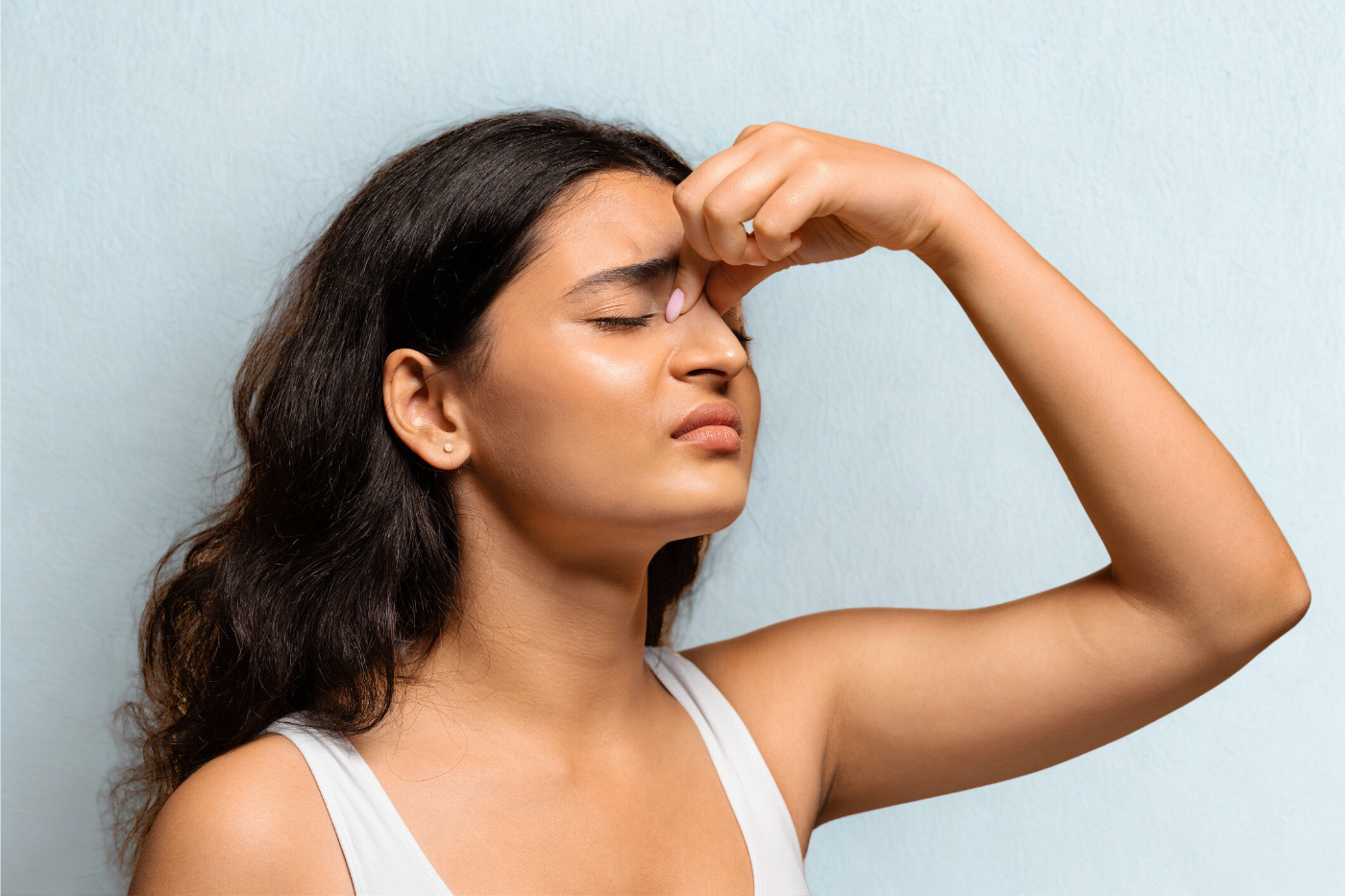 Woman suffering from nose bleeds