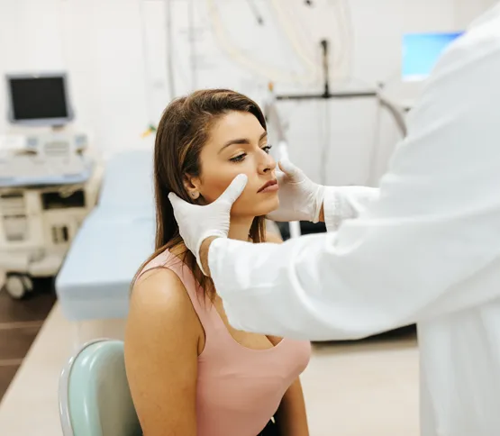 Doctor examining female patient's sinus cavity