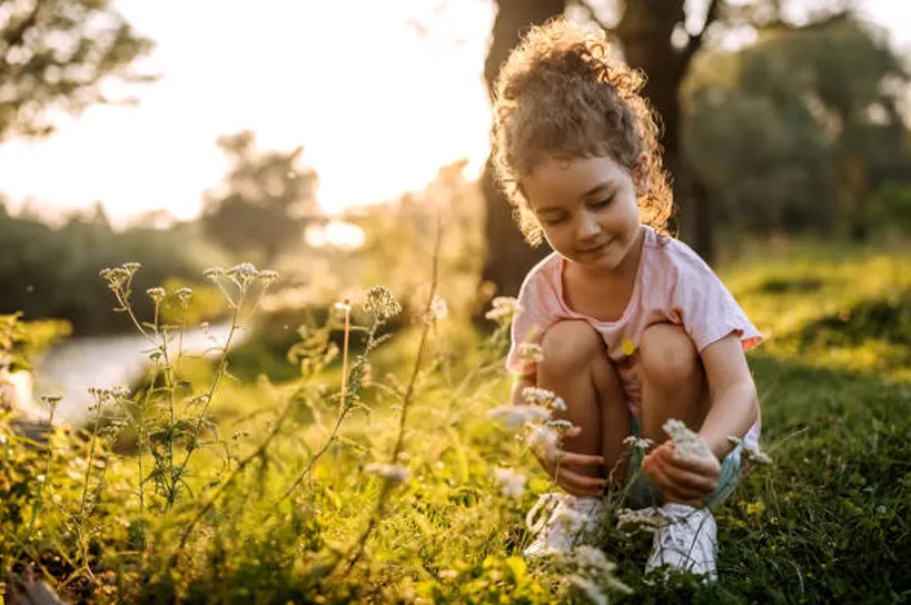 Young girl picking flowers